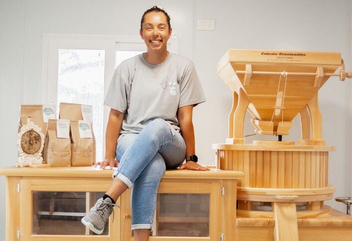 Shiane Lea with her on-farm flour mill, imported from Austria