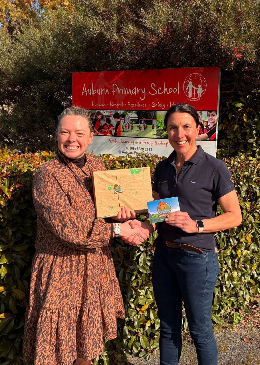 Auburn Primary School principal Skye Irwin receiving a George the Farmer book pack from Rabo Client Council member Claire Catford.
