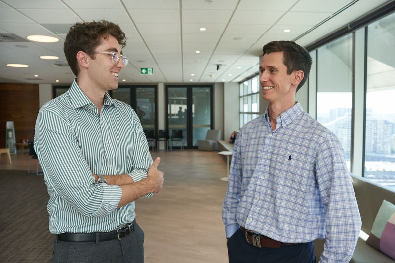 Two staff talking together