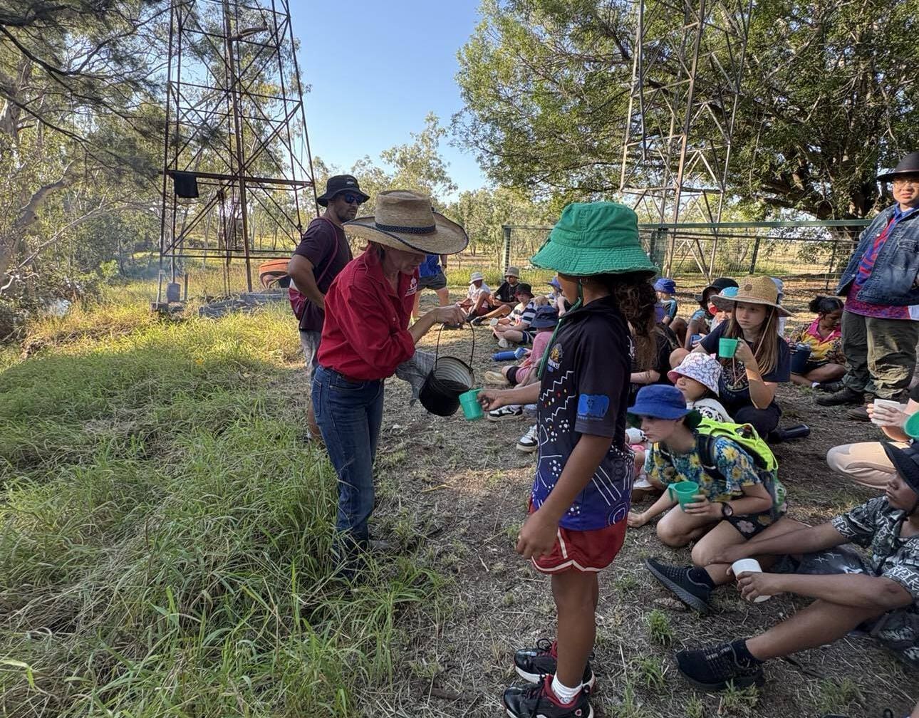 Michelle sharing ‘billy tea’ with a school group on-farm, helping educate and build awareness around rural life and industries.
