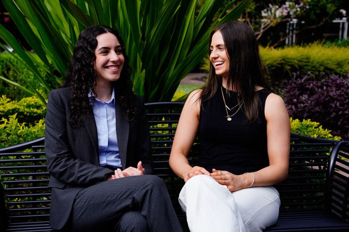 Two staff talking together