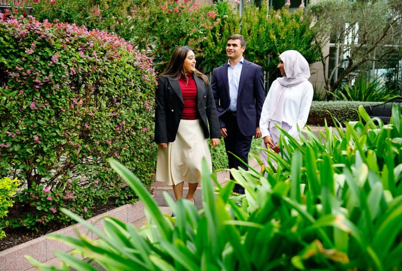 Three staff members walking together having a conversation