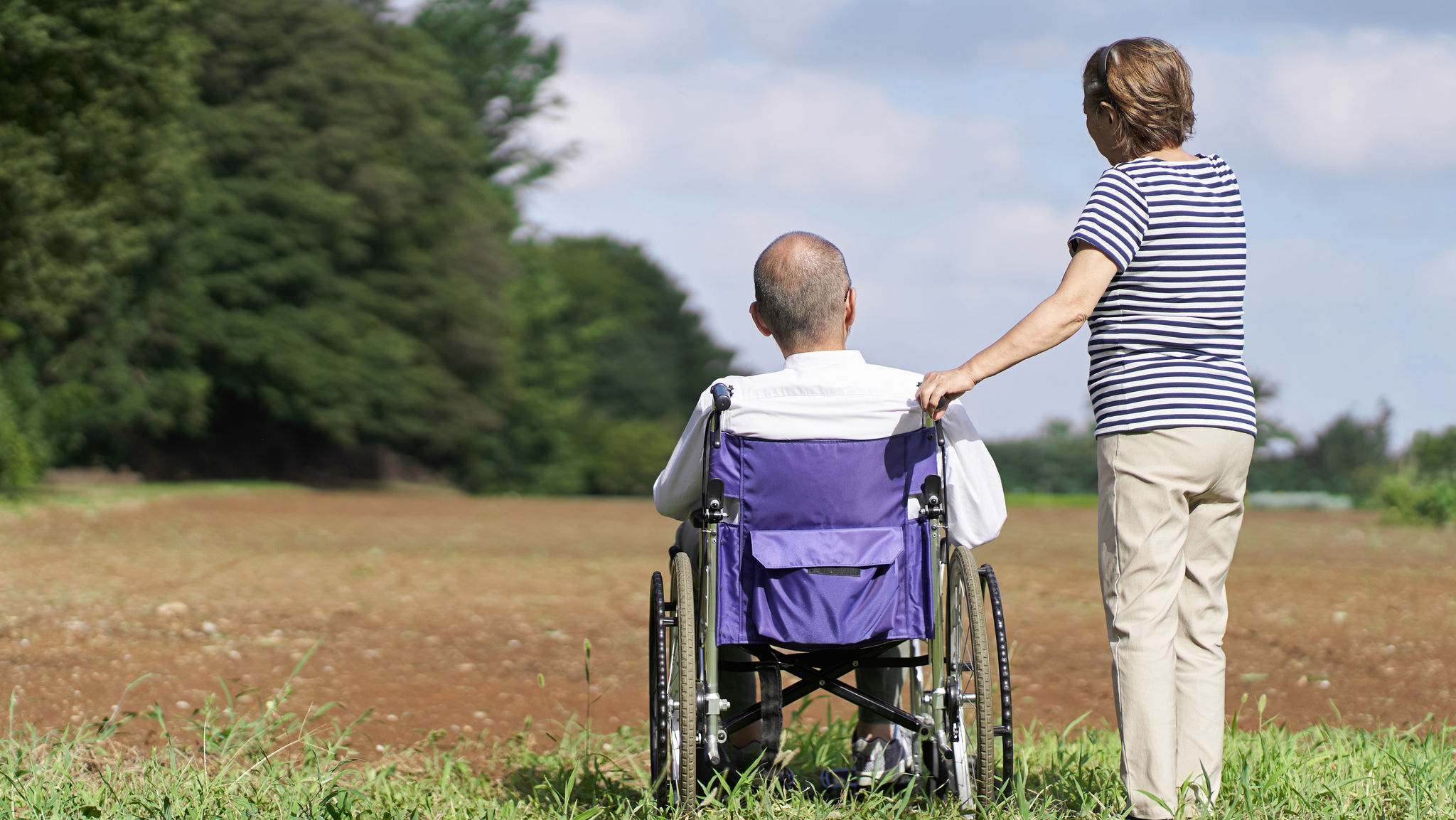 Elderly couple looking at the field